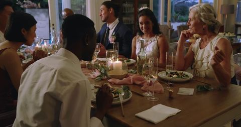 Guests Enjoying Elegant Wedding Reception Dinner Indoors