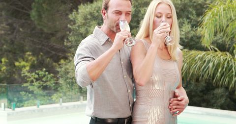 Elegant Couple Toasting by Poolside