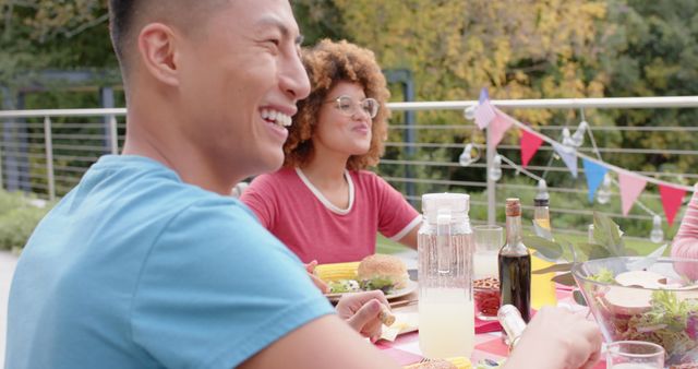 Friends Enjoying Meal Outdoors with Laughter and Joy - Download Free Stock Images Pikwizard.com