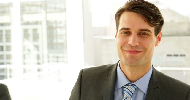 Confident Businessman in Office with Bright Natural Light - Download Free Stock Images Pikwizard.com