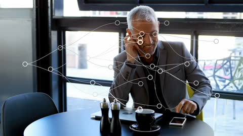 Businessman Connecting through Virtual Networks in Modern Cafe