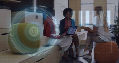 Diverse Businesswomen Discussing Hologram Technology in Office Lounge