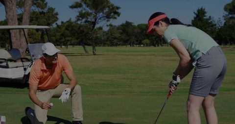 Golfers Engaging in Putt Competition on Green