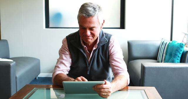 Senior Man Smiling While Using Tablet at Home - Download Free Stock Images Pikwizard.com