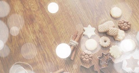 Baking Christmas Cookie Assortment with Star Cutters, Cinnamon Sticks and Powdered Sugar