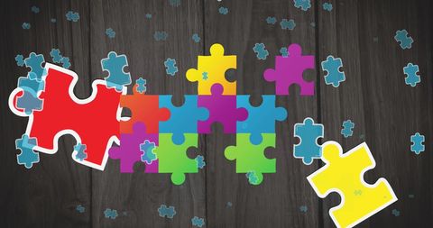 Scattered Colorful Puzzle Pieces on Wooden Background