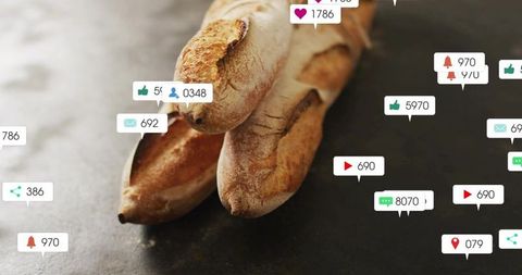 Artisan baguettes resting on slate surface with floating social media notifications