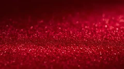 Racking Focus Showing Red Glitter Flakes Shimmering Under Shifting Light Closeup Video