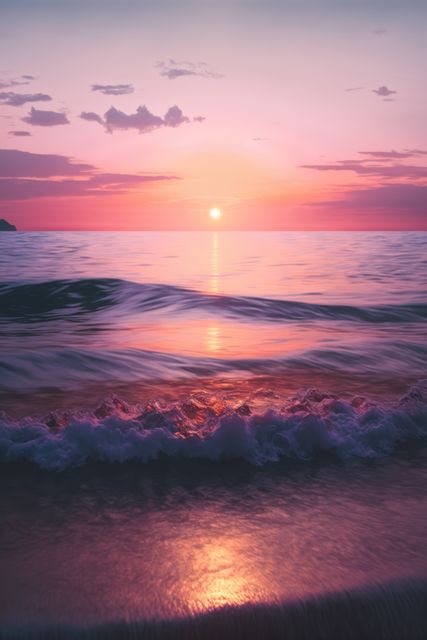 This image captures a breathtaking sunset over a calm ocean with gentle waves lapping the shore. The sky displays a stunning gradient of warm colors ranging from orange to pink and purple. Ideal for use in travel promotions, nature-themed blog posts, or relaxation and meditation media. The peaceful scene evokes tranquility and natural beauty.