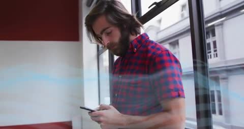 Young Professional Engaging With Technology by Urban Window