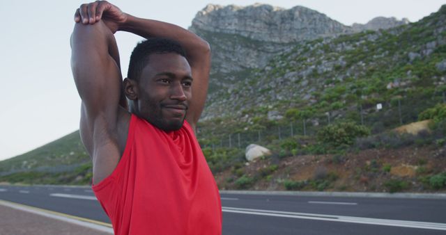 Man Stretching Muscles Before Outdoor Workout on Mountain Road - Download Free Stock Images Pikwizard.com