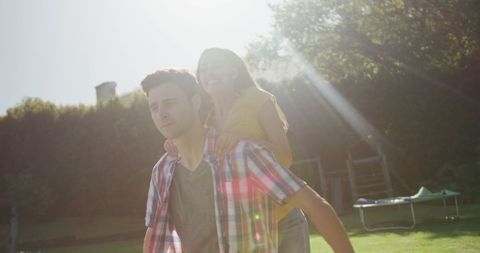 Happy Couple Piggybacking in Sunny Park