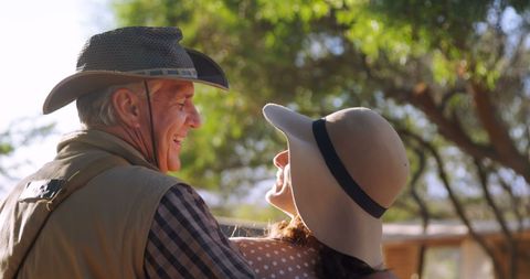 Senior Couple Enjoying a Warm Moment Outdoors Under the Sun