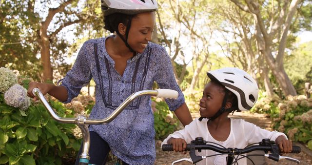 Smiling African American Mother and Daughter Riding Bicycles Outdoors - Download Free Stock Images Pikwizard.com