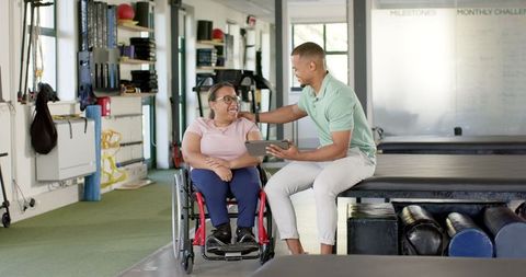 Therapist Assisting Woman in Wheelchair at Rehabilitation Center