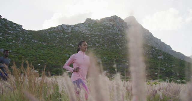 Fit Young Woman Running Outdoors in Nature with Mountainous Background - Download Free Stock Images Pikwizard.com