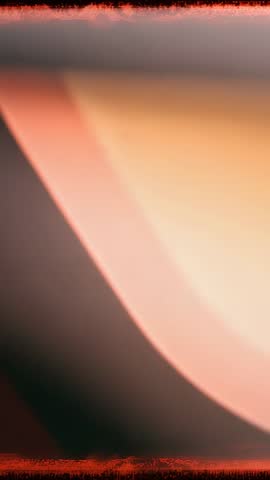 Vertical Abstract Gradient Video Showing Soft Orange Curve Shifting Across Muted Gray Field