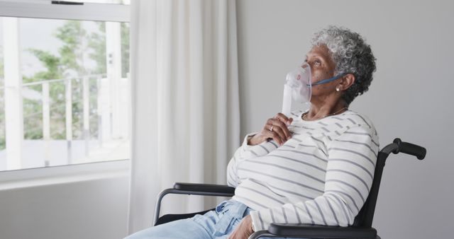 Elderly Woman Using Oxygen Mask in Wheelchair at Home Near Window - Download Free Stock Images Pikwizard.com