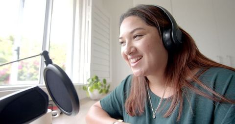 Joyful Biracial Woman Podcasting from Home with Headphones - Download Free Stock Images Pikwizard.com
