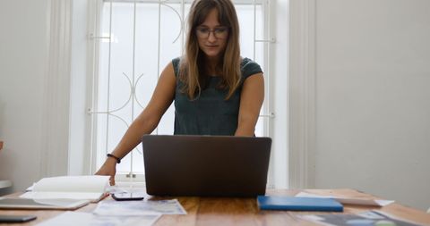 Focused Businesswoman Working on Laptop in Office Environment - Download Free Stock Images Pikwizard.com