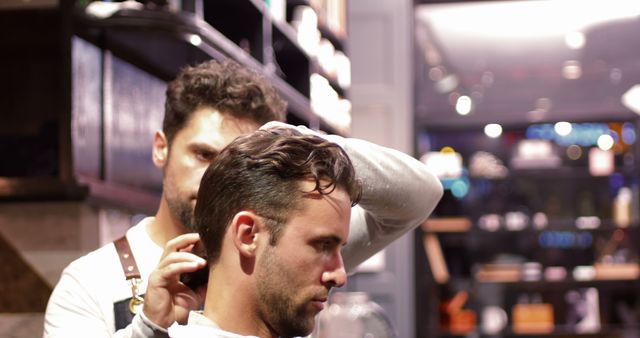 Man getting his hair trimmed with trimmer in barber shop