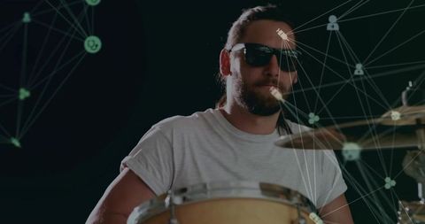 Drummer performing with digital data overlay in studio