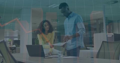 Team collaboration reviewing analytics and charts in modern office with laptop