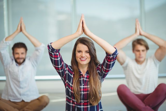 Business executives practicing yoga in an office setting, promoting wellness and relaxation. Ideal for illustrating corporate wellness programs, team building activities, and workplace health initiatives. Useful for articles, blogs, and promotional materials focused on mental health, stress relief, and fitness in professional environments.