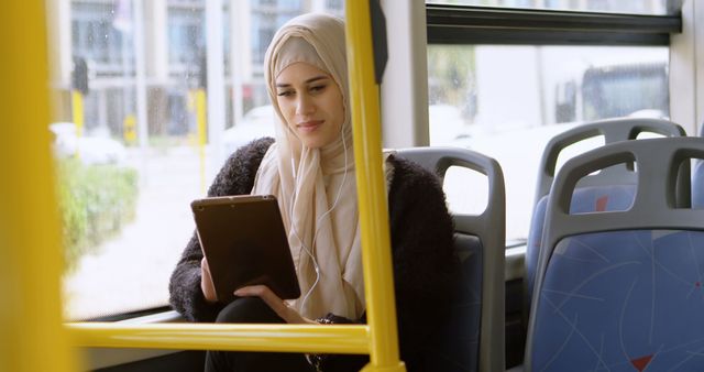 Young Muslim Woman Using Tablet on Bus - Download Free Stock Images Pikwizard.com