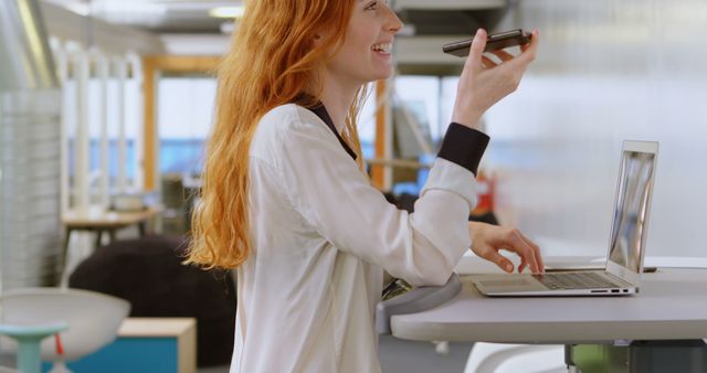 Happy Businesswoman Using Voice Assistant on Smartphone in Modern Office - Download Free Stock Images Pikwizard.com