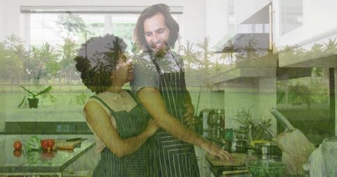 Couple in Aprons Cooking Together, Enjoying Kitchen Moments