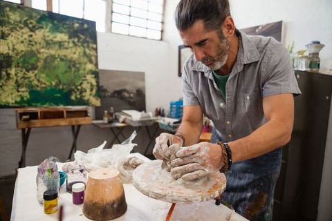 Middle-Aged Sculptor Shaping Clay at Studio Workspace - Download Free Stock Images Pikwizard.com