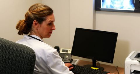 Female Doctor Analyzing X-Ray in Medical Office - Download Free Stock Images Pikwizard.com