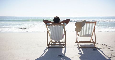 Man Relaxing on Beach with Empty Chair Suggesting absent Companion - Download Free Stock Images Pikwizard.com