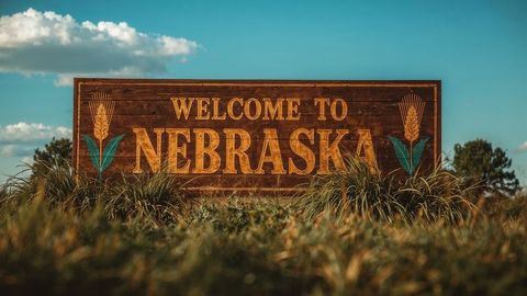 Welcome to nebraska sign amidst pristine nature