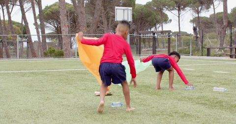 Youthful Friends Engaging in Active Play on Sports Field