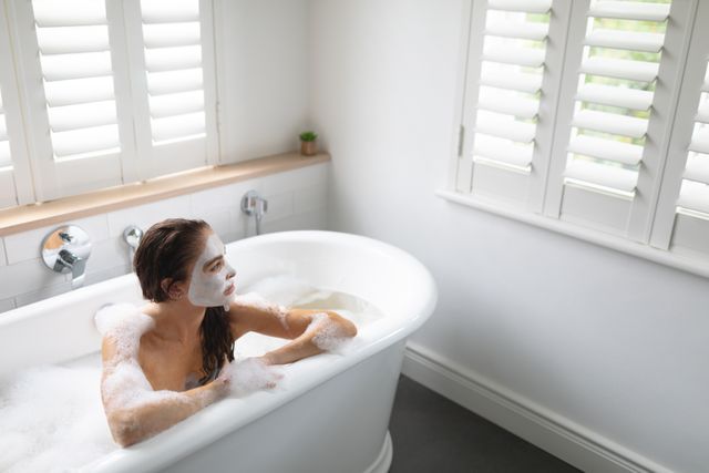 Woman Relaxing in Bathtub with Face Mask - Download Free Stock Photos Pikwizard.com