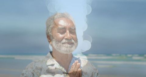 Senior Man Meditating with Enlightenment Symbolism by Ocean