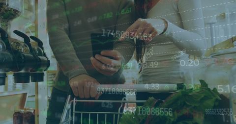 Couple Shopping with Smartphone Overlaid by Finance Data