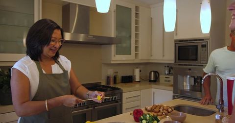 Asian couple preparing fresh ingredients in modern kitchen