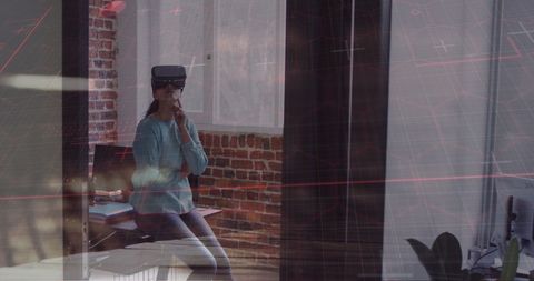 Businessman with VR Headset Experiencing Virtual Reality in Modern Office