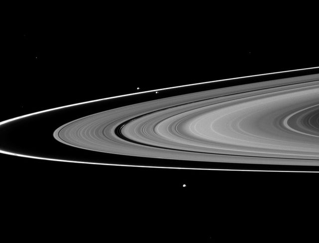 The F ring shepherds, Prometheus and Pandora, join Epimetheus in this image taken by NASA Cassini spacecraft of three of Saturn moons and the rings.