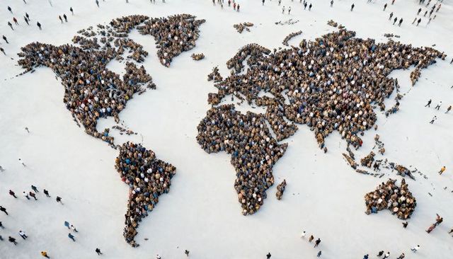 Forming human world map from above, crowd shaping continents symbolizing global unity