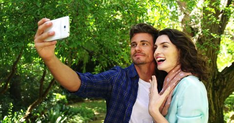 Happy Couple Taking Selfie Together in Summer Park