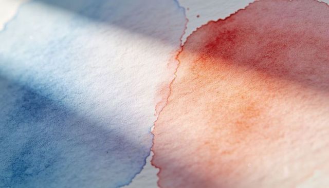 Showing blue and red-orange watercolor washes on textured paper with diagonal shadow