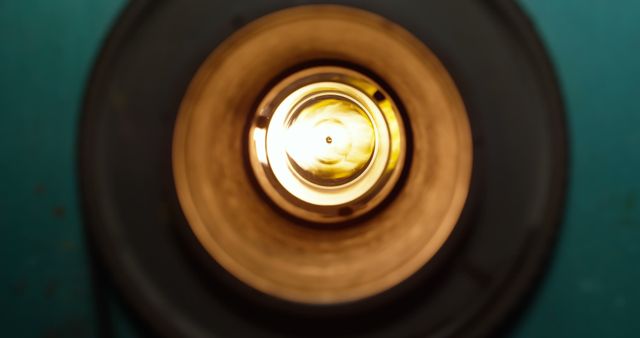 This close-up view of a glowing light bulb emphasizes the circular shape and illumination. Ideal for use in topics related to energy, vintage decor, interior design, and lighting. Perfect for blog articles, marketing materials, or presentations focusing on home lighting solutions and ambiance.