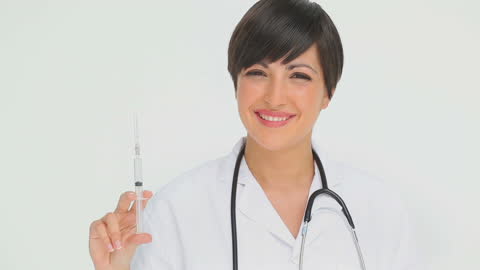 Smiling Female Doctor Holding Syringe Ready for Vaccination