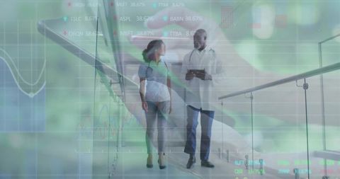 Clinician Consulting Pregnant Patient While Reviewing Tablet with Augmented Data Overlays