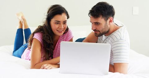 Couple Enjoying Laptop Time Together in Bedroom