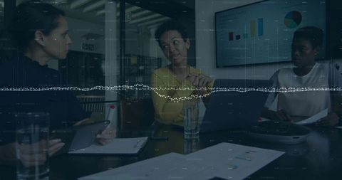 Diverse Businesswomen Discussing Data Insights in Modern Office